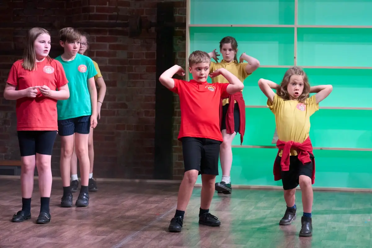 Children performing together on stage during an IntoOpera production